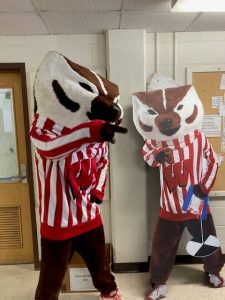 Bucky Badger meeting a cutout poster of Bucky Badger at Hasler Labs Open House June 21, 2023.