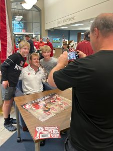 Football player Hunter Wohler at the Muskego Public Library taking photos with fans and fellow readers.