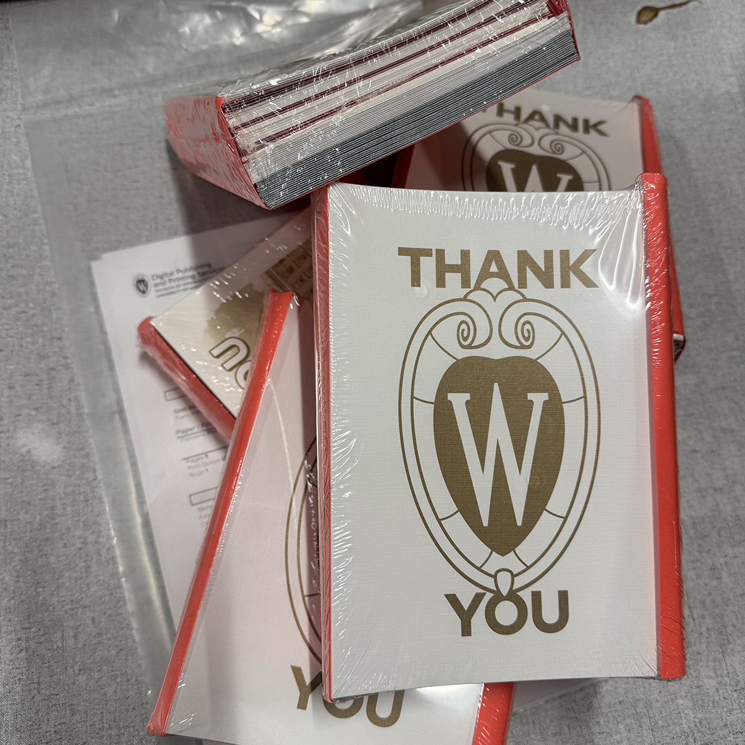 A pile of DPPS Gold Ink Thank You Card packs at our shipping table.